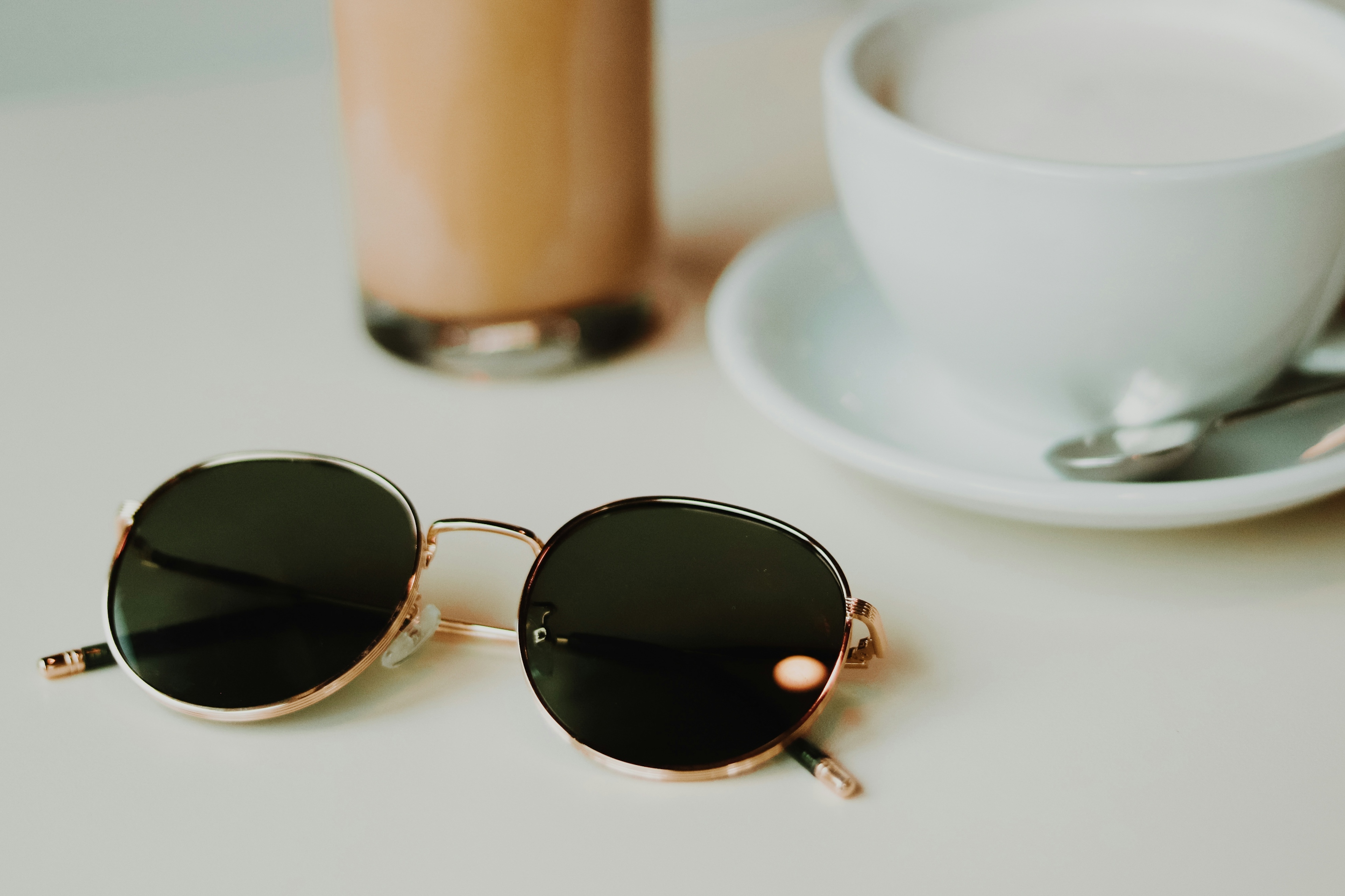 Silver aviator sunglasses on a white saucer